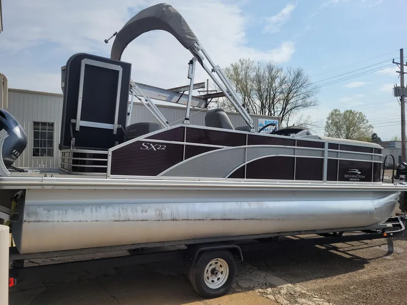 Slide: The Image of 2020 Bennington 22 SSBXP pontoon boat on trailer, side view, outdoors. - 8