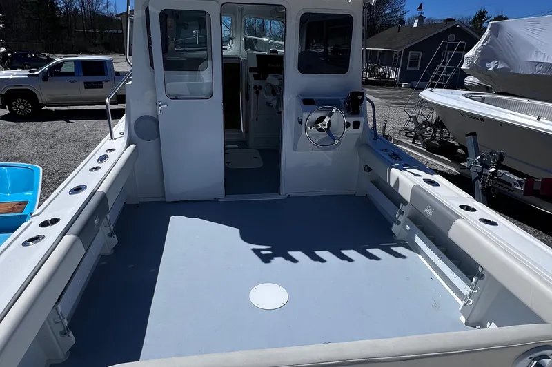 Slide: The Image of 2022 Steiger Craft 31 Chesapeake boat deck with steering wheel and seating. - 12