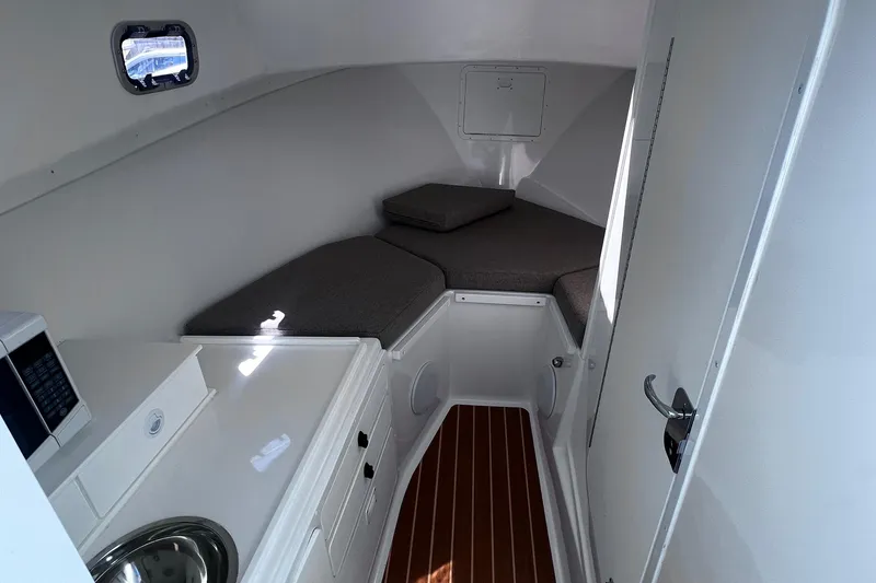 Slide: The Image of 2022 Steiger Craft 31 Chesapeake cabin interior with kitchenette and seating area. - 21