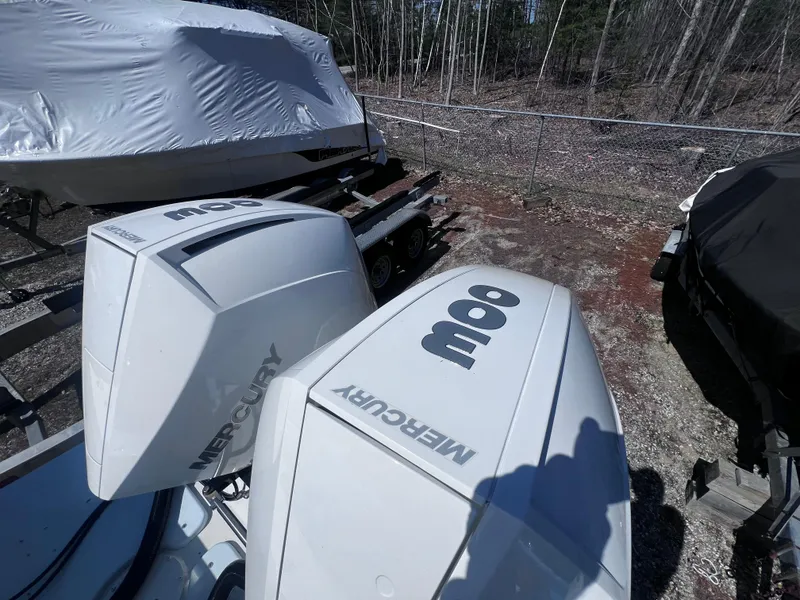 Slide: The Image of Twin Mercury outboard engines on a 2022 Steiger Craft 31 Chesapeake boat, parked outdoors. - 22