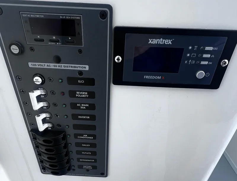 Slide: The Image of Electrical control panel on 2022 Steiger Craft 31 Chesapeake boat, featuring Xantrex Freedom X display. - 27