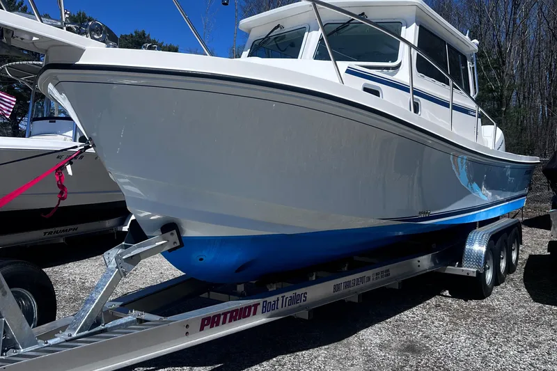 Slide: The Image of 2022 Steiger Craft 31 Chesapeake boat on Patriot trailer, parked outdoors. - 3