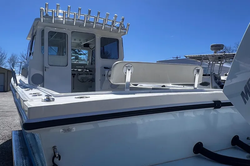 Slide: The Image of 2022 Steiger Craft 31 Chesapeake boat, rear view, showcasing spacious deck and fishing rod holders. - 30