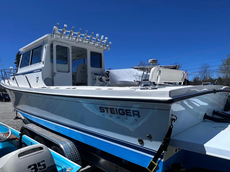 Slide: The Image of 2022 Steiger Craft 31 Chesapeake boat on trailer under clear blue sky. - 5