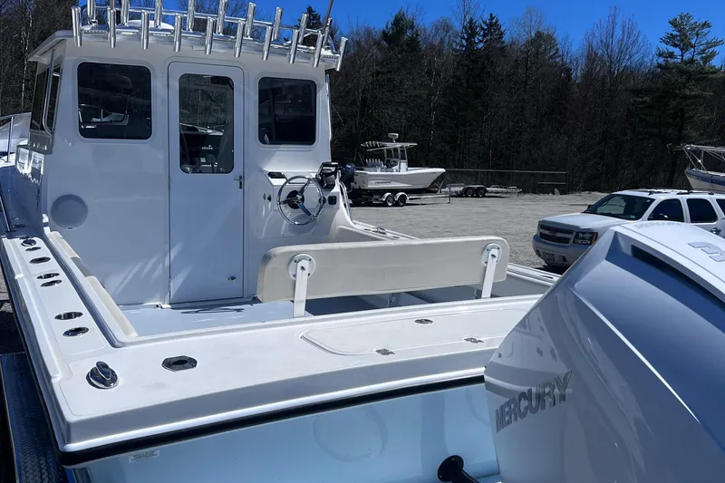 Slide: The Image of 2022 Steiger Craft 31 Chesapeake boat with Mercury engine, docked outdoors. - 8