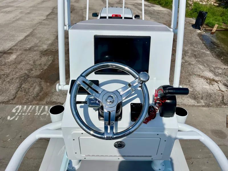 Slide: The Image of 2022 Shallow Sport 20 Classic boat console with steering wheel and controls. - 10