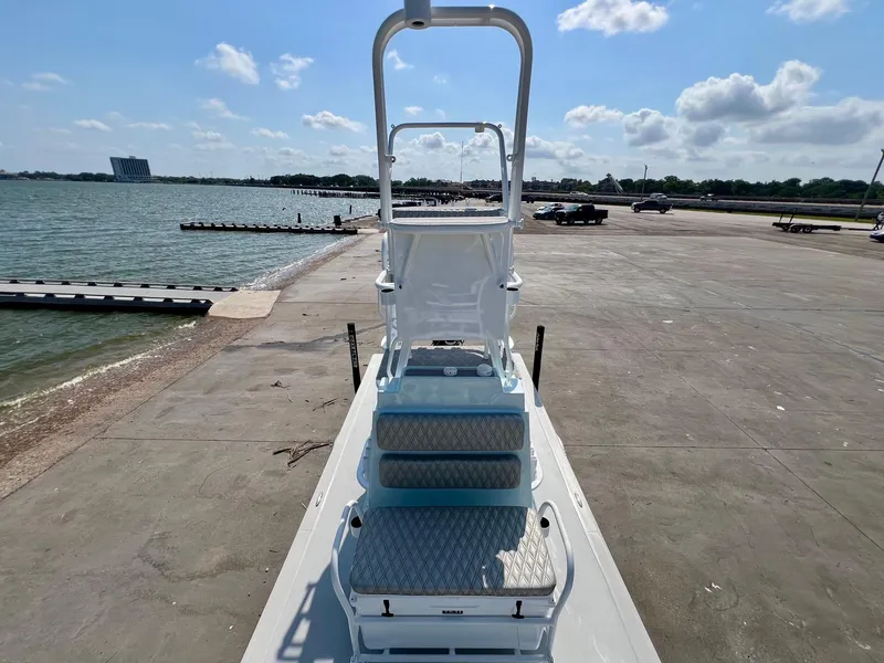 Slide: The Image of 2022 Shallow Sport 20 Classic boat on a concrete dock by the water. - 16