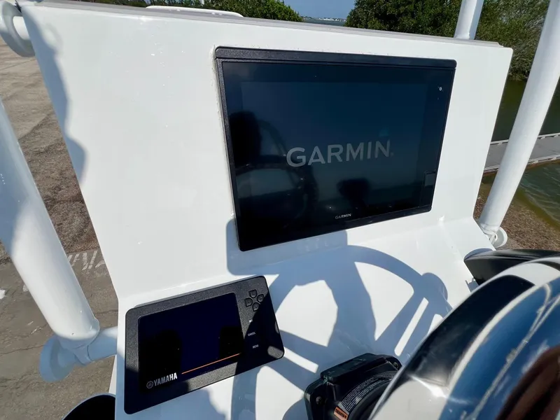 Slide: The Image of 2022 Shallow Sport 20 Classic boat dashboard with Garmin and Yamaha displays. - 18