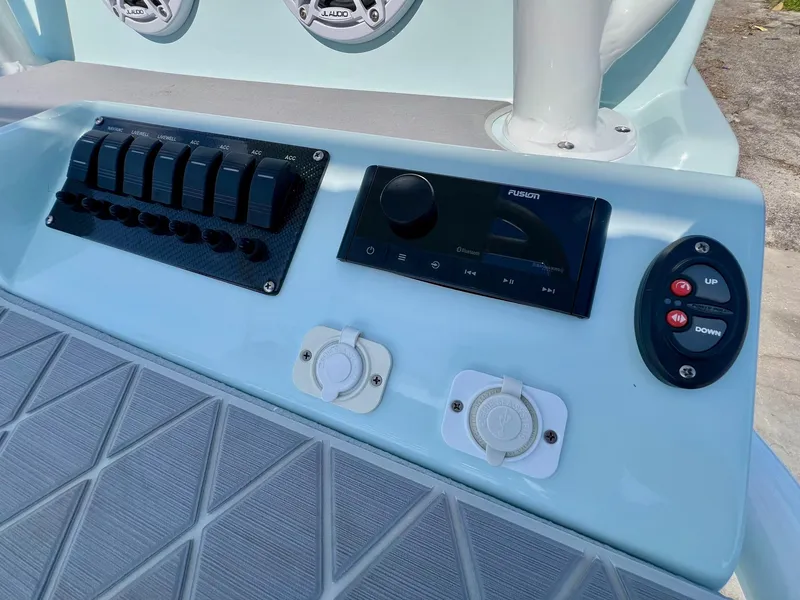 Slide: The Image of Control panel of 2022 Shallow Sport 20 Classic boat with switches and audio system. - 19