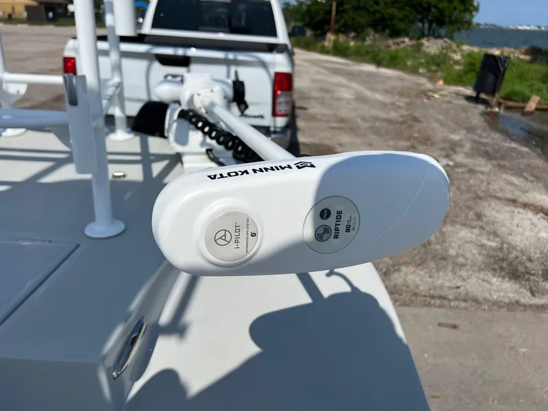 Slide: The Image of 2022 Shallow Sport 20 Classic boat with Minn Kota trolling motor, parked near a waterfront. - 20