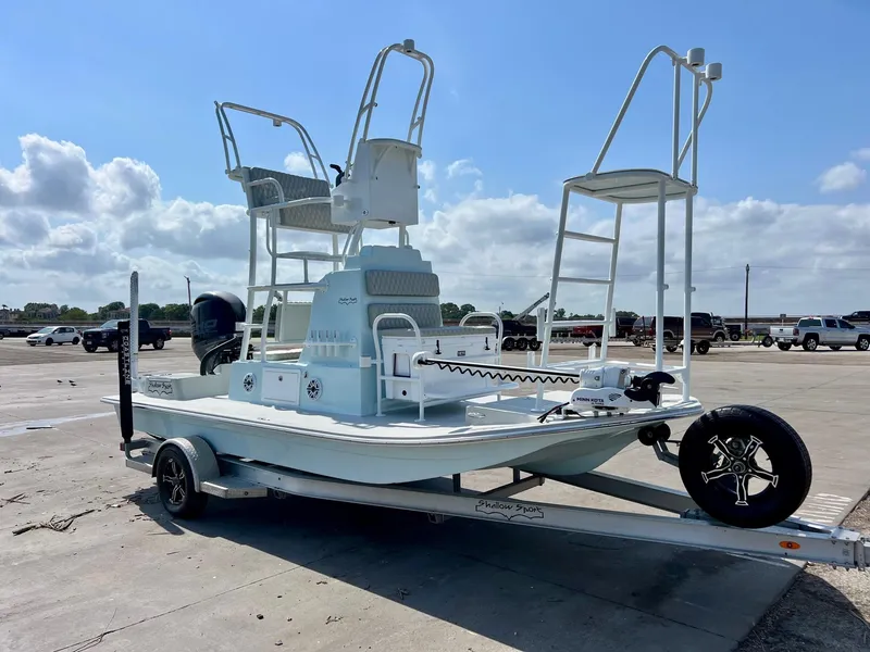 Slide: The Image of 2022 Shallow Sport 20 Classic boat on trailer under a clear sky. - 5