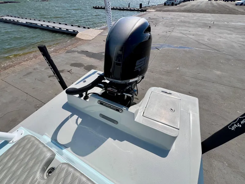 Slide: The Image of 2022 Shallow Sport 20 Classic boat with outboard motor at a dockside. - 7