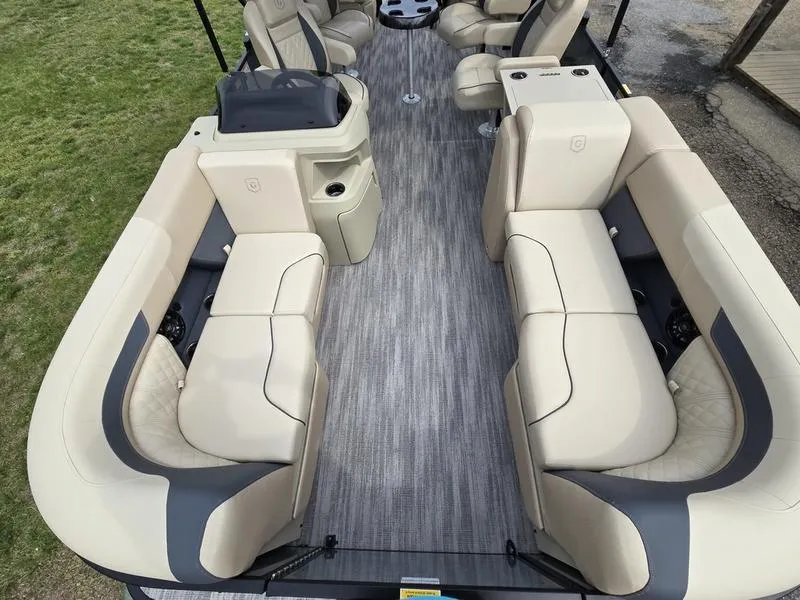 Slide: The Image of 2025 Godfrey Sweetwater 2286 QS pontoon boat interior with beige seating and gray flooring. - 11