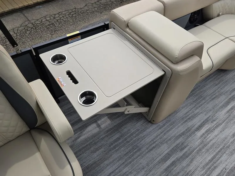 Slide: The Image of 2025 Godfrey Sweetwater 2286 QS boat interior with foldable table and cup holders. - 3
