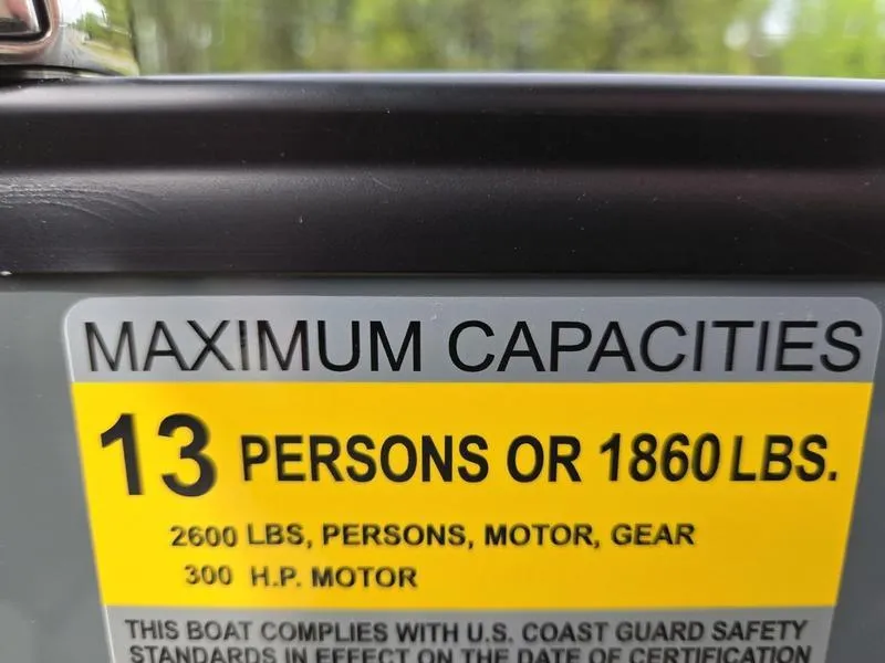 Slide: The Image of 2025 Godfrey Sweetwater boat capacity label: 13 persons or 1860 lbs, 300 HP motor. - 7