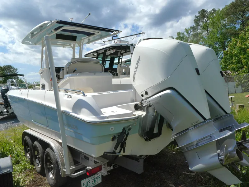 Slide: The Image of 2022 Boston Whaler 270 Dauntless boat with dual engines on a trailer. - 1