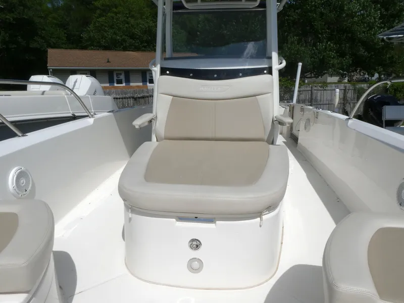 Slide: The Image of 2022 Boston Whaler 270 Dauntless boat interior with cushioned seating and console. - 10