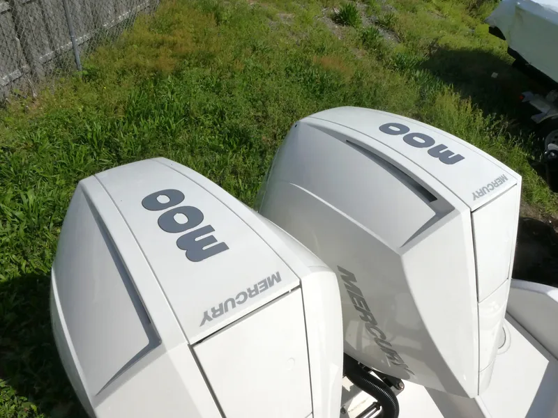 Slide: The Image of Twin Mercury outboard engines on a 2022 Boston Whaler 270 Dauntless boat. - 2