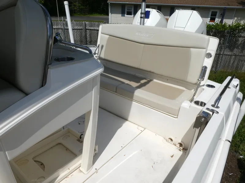 Slide: The Image of 2022 Boston Whaler 270 Dauntless boat interior with beige seating and storage compartments. - 4
