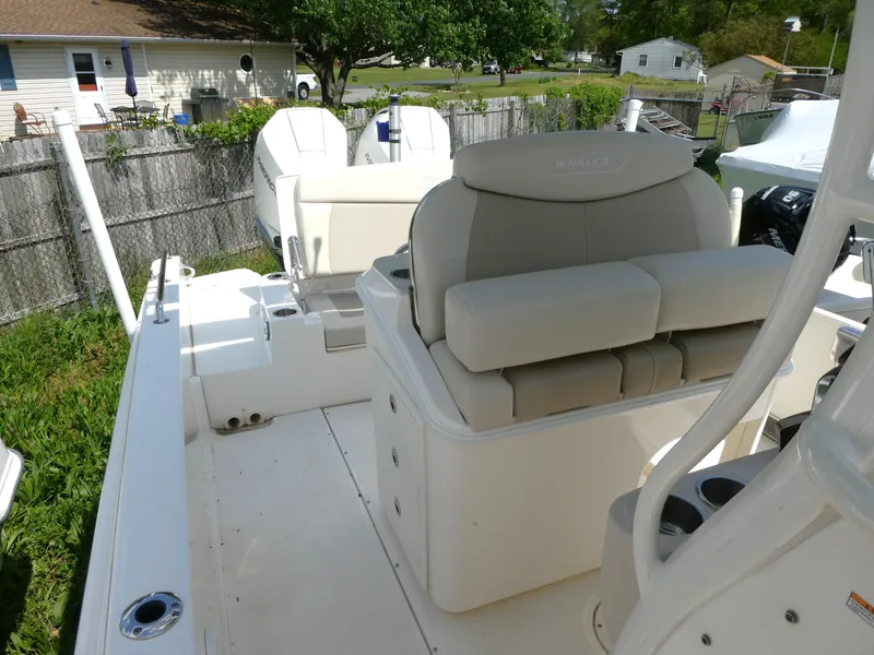 Slide: The Image of 2022 Boston Whaler 270 Dauntless boat interior with seating and storage, outdoor setting. - 6