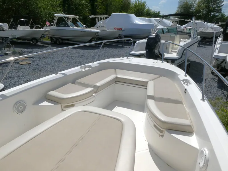 Slide: The Image of 2022 Boston Whaler 270 Dauntless boat with spacious seating, docked outdoors. - 8
