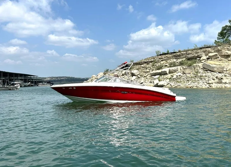 Slide: The Image of Red 2004 Sea Ray 240 Select boat on a lake with rocky shoreline. - 12