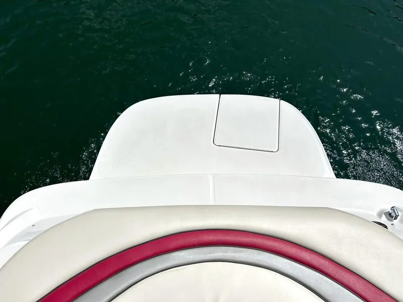 Slide: The Image of 2004 Sea Ray 240 Select boat stern with red and white seating, overlooking water. - 19