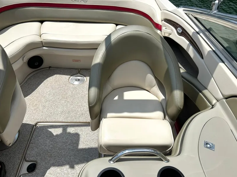 Slide: The Image of 2004 Sea Ray 240 Select boat interior with beige seating and carpeted floor. - 24