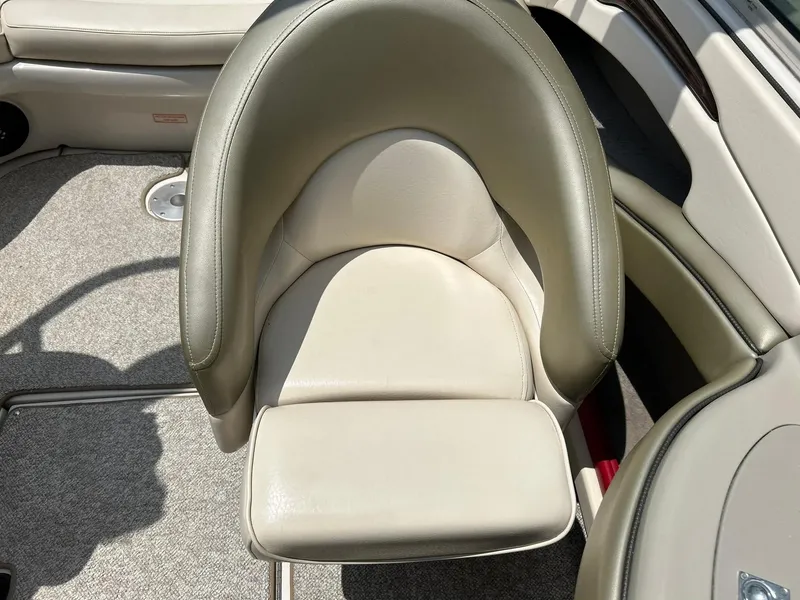 Slide: The Image of 2004 Sea Ray 240 Select boat seat, beige leather, comfortable design, luxury marine interior. - 25