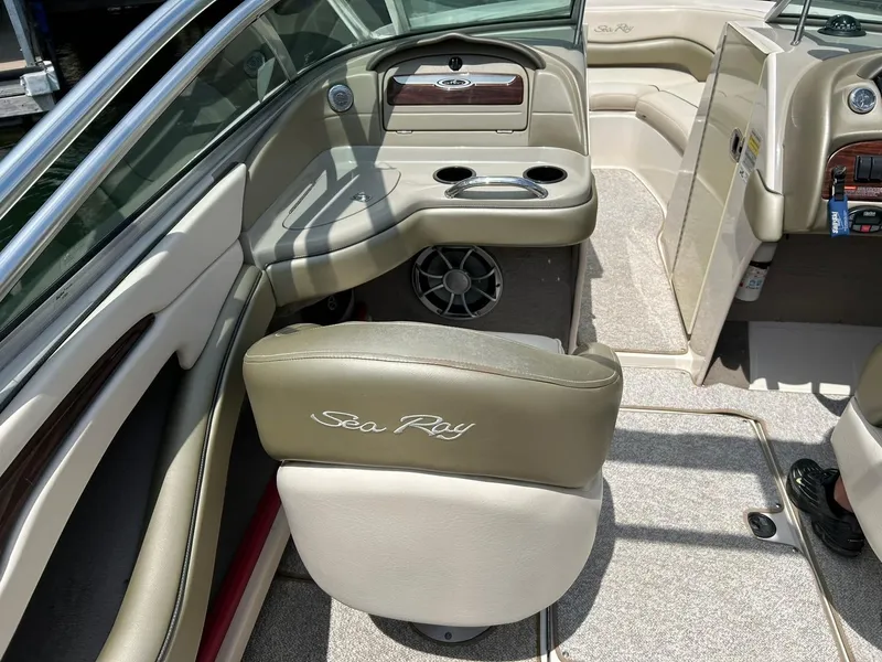 Slide: The Image of 2004 Sea Ray 240 Select boat interior with seating, cup holders, and dashboard. - 26