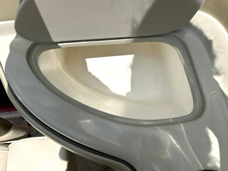 Slide: The Image of 2004 Sea Ray 240 Select boat seat compartment, open and empty. - 28