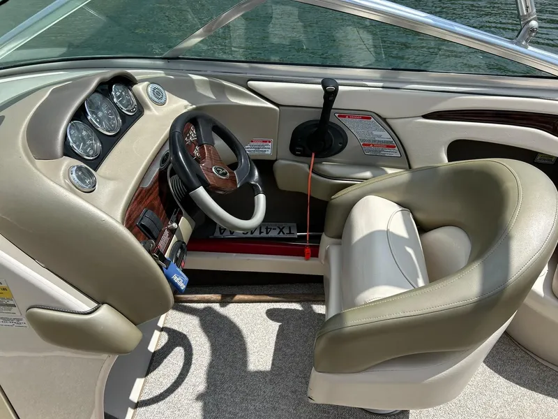 Slide: The Image of Interior of 2004 Sea Ray 240 Select boat with steering wheel and control panel. - 29