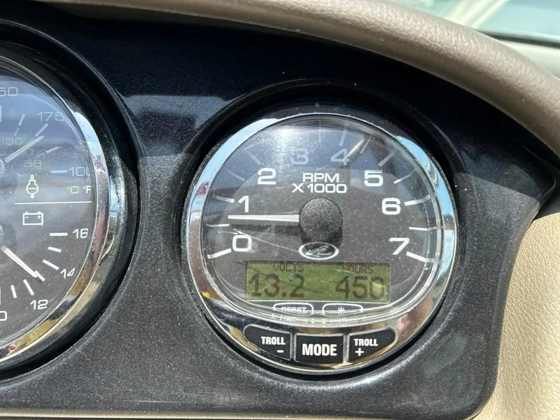 Slide: The Image of Close-up of 2004 Sea Ray 240 Select tachometer displaying RPM and digital readings. - 31