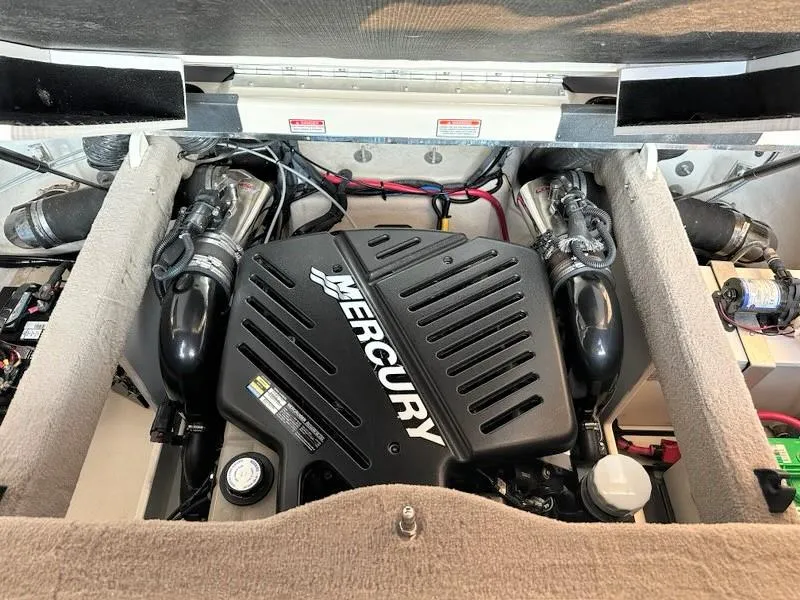 Slide: The Image of Engine compartment of a 2004 Sea Ray 240 Select with a Mercury engine. - 32