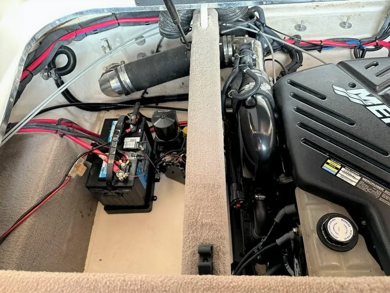 Slide: The Image of Engine compartment of a 2004 Sea Ray 240 Select boat, showing battery and engine components. - 33