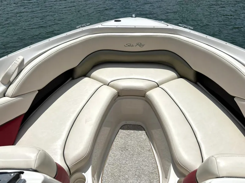 Slide: The Image of 2004 Sea Ray 240 Select boat interior with cushioned seating and water view. - 35