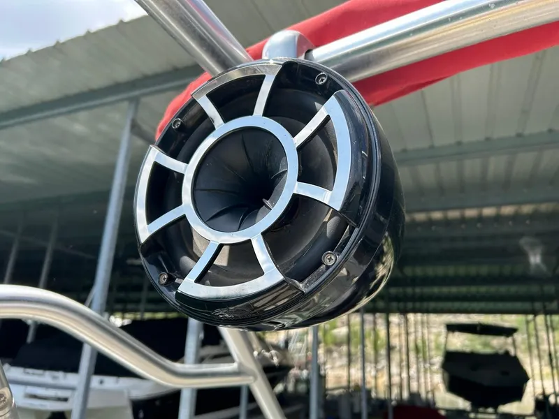 Slide: The Image of Close-up of a speaker on a 2004 Sea Ray 240 Select boat under a covered dock. - 44