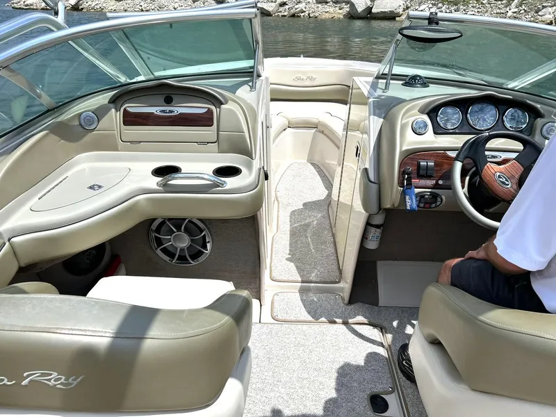 Slide: The Image of Interior of a 2004 Sea Ray 240 Select boat with beige seating and dashboard. - 5