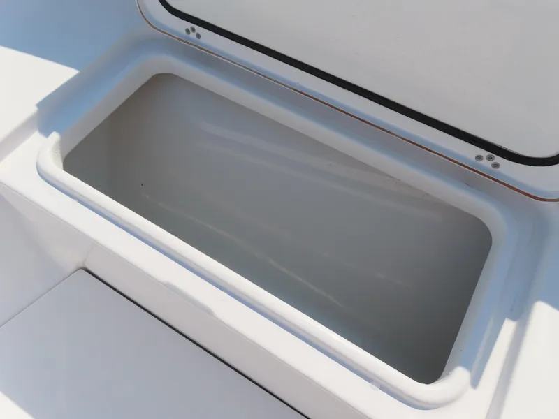 Slide: The Image of Open storage compartment on 2021 Sportsman Open 282 Center Console boat. - 16