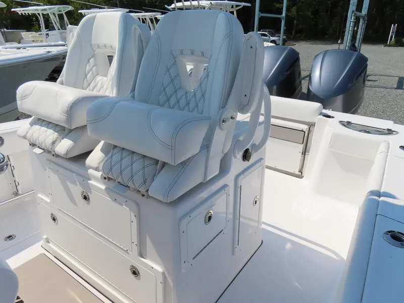 Slide: The Image of 2021 Sportsman Open 282 Center Console with luxurious white seating and storage compartments. - 25