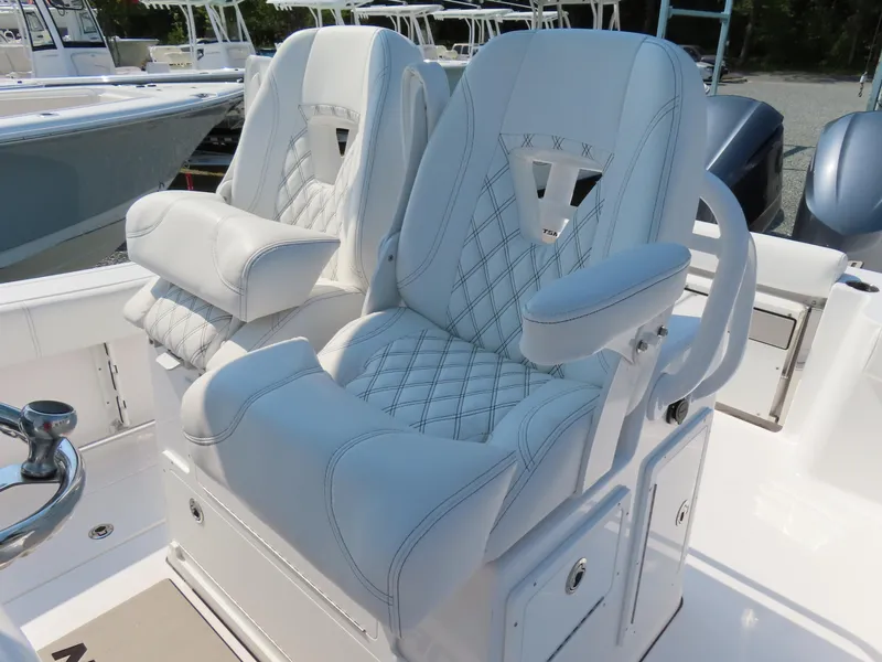 Slide: The Image of Luxurious seating on 2021 Sportsman Open 282 Center Console boat, featuring plush white upholstery. - 27