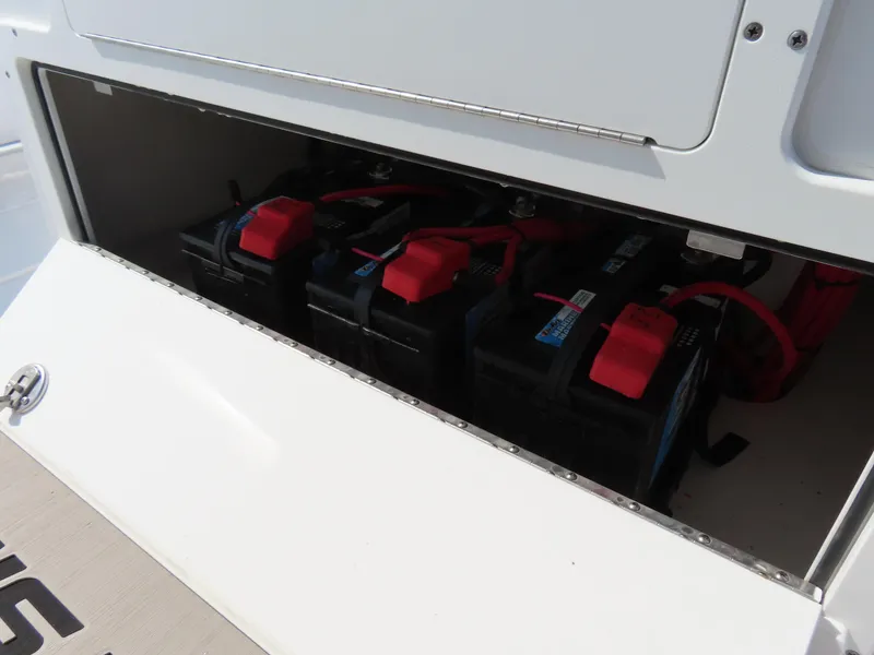 Slide: The Image of 2021 Sportsman Open 282 Center Console boat battery compartment with multiple batteries. - 29