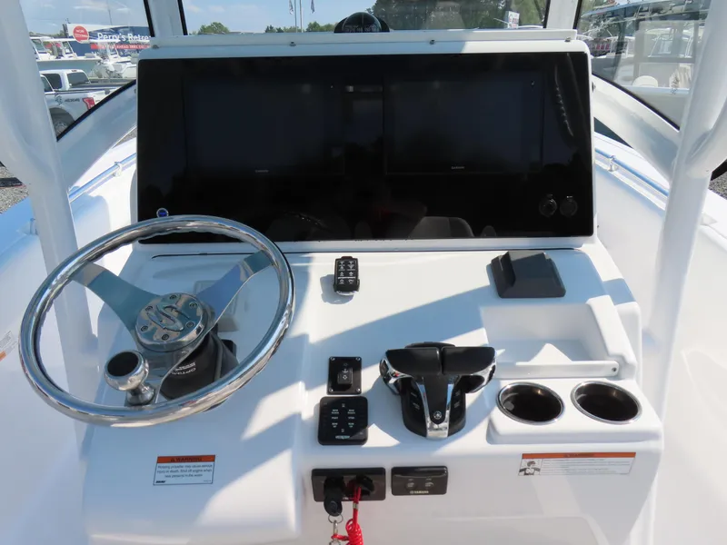 Slide: The Image of 2021 Sportsman Open 282 Center Console dashboard with steering wheel and controls. - 30
