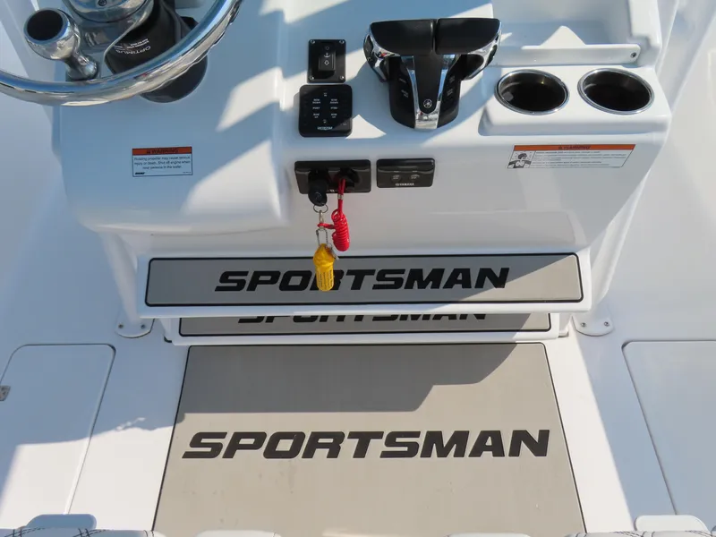 Slide: The Image of 2021 Sportsman Open 282 Center Console helm with controls and branding. - 32