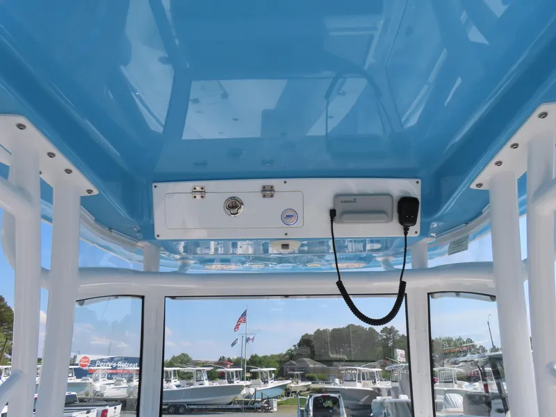 Slide: The Image of 2021 Sportsman Open 282 Center Console boat interior with blue ceiling and control panel. - 33