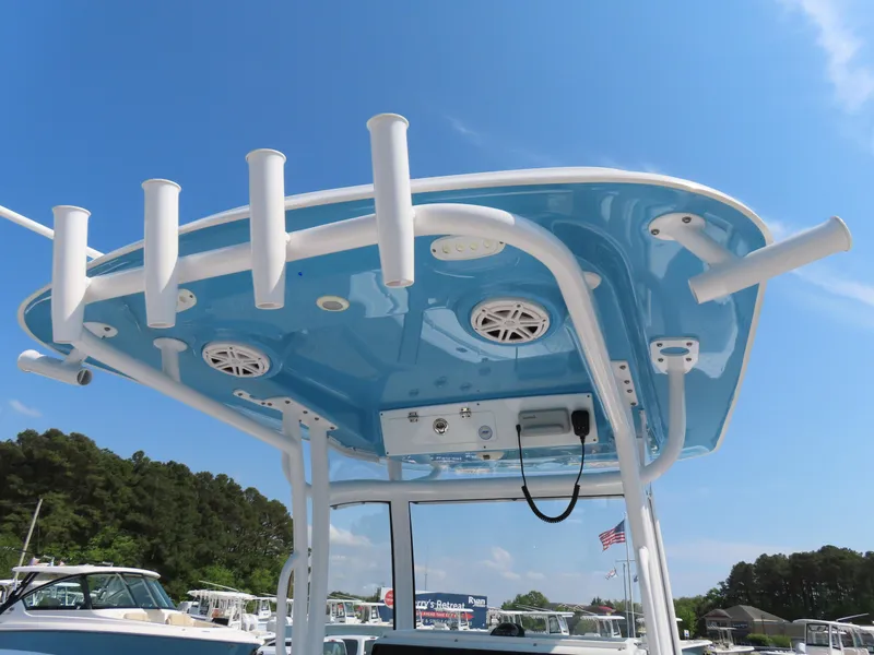 Slide: The Image of 2021 Sportsman Open 282 Center Console boat with blue T-top and rod holders. - 34