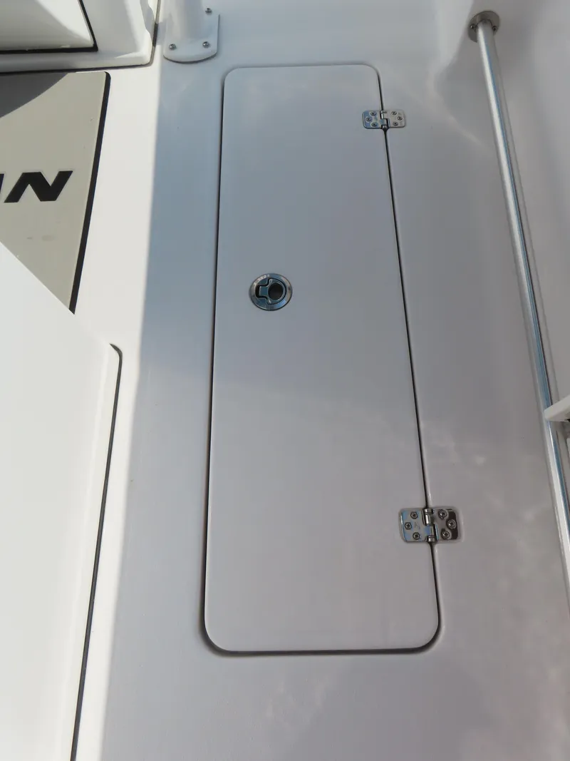 Slide: The Image of 2021 Sportsman Open 282 Center Console hatch with secure latch and hinges. - 36