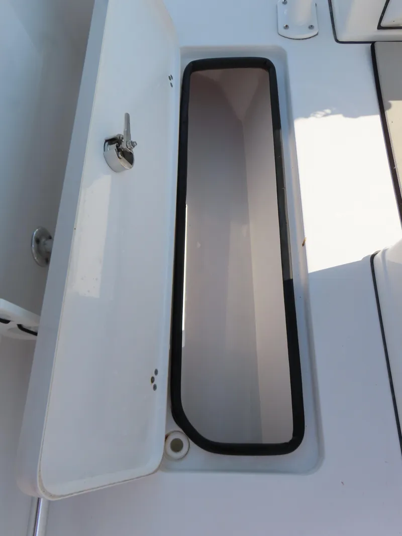 Slide: The Image of Open storage compartment on 2021 Sportsman Open 282 Center Console boat. - 39