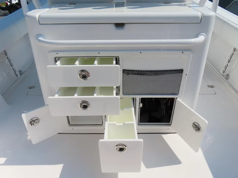 Slide: The Image of 2021 Sportsman Open 282 Center Console storage compartments with open drawers and doors. - 42