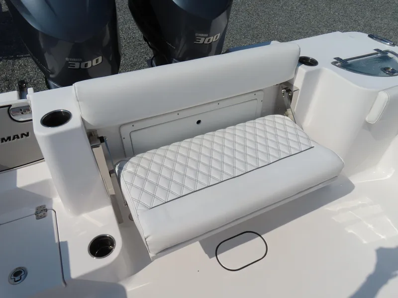 Slide: The Image of 2021 Sportsman Open 282 Center Console boat with cushioned seating and dual engines. - 44